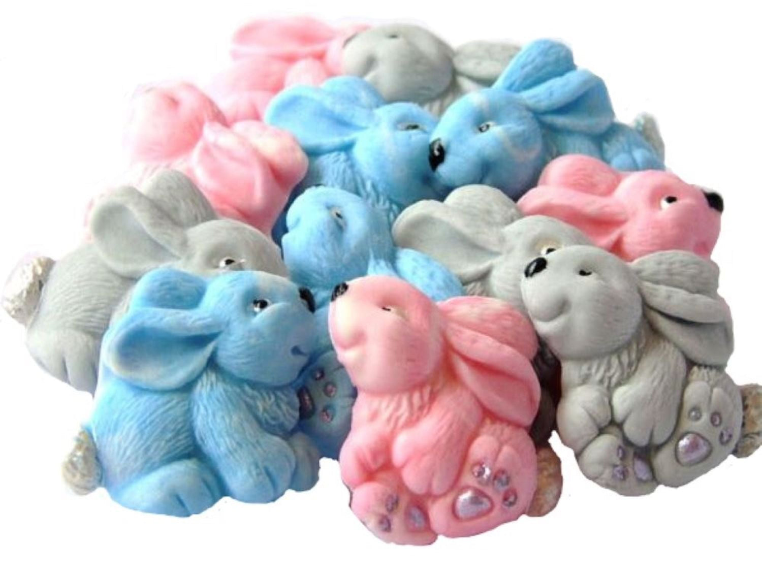 A group of rabbit cake toppers. The cake toppers are blue, pink and grey.
