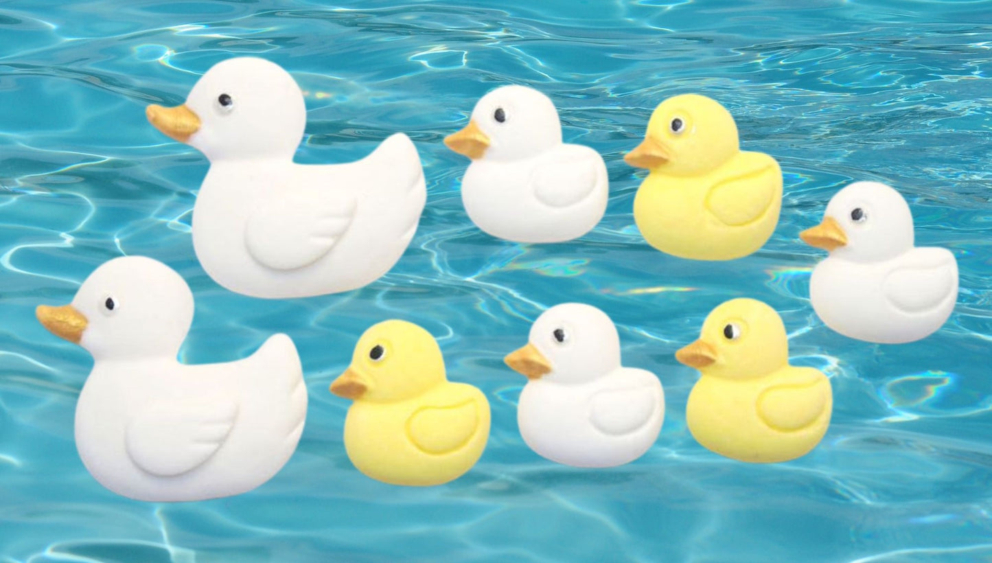 Edible White and yellow ducks cupcake toppers shown floating on blue water