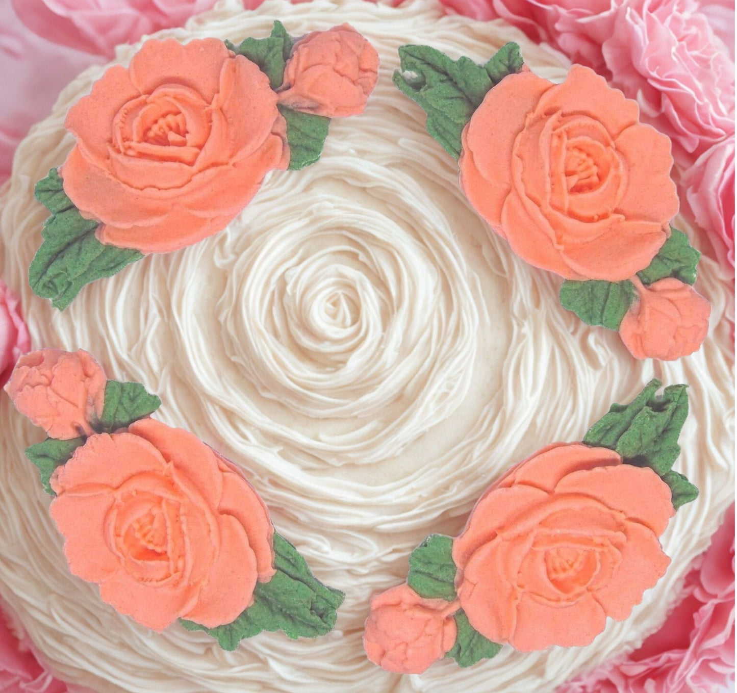 Decorative cake with Peach rose garland and green leaves on a white cake background