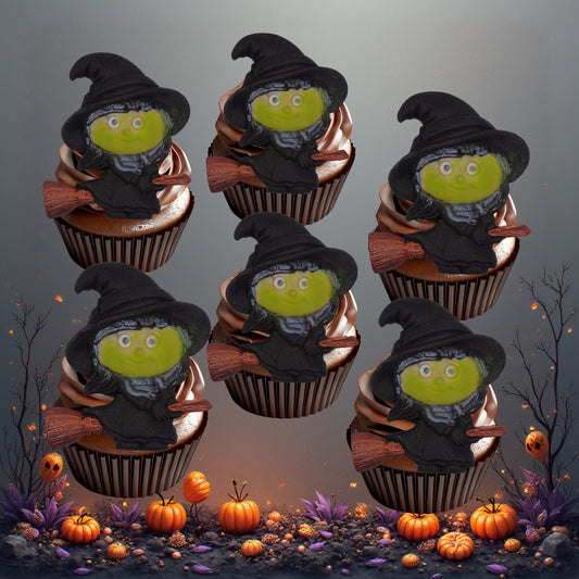 Cupcakes decorated with edible witch-themed decorations on a Halloween-themed background.