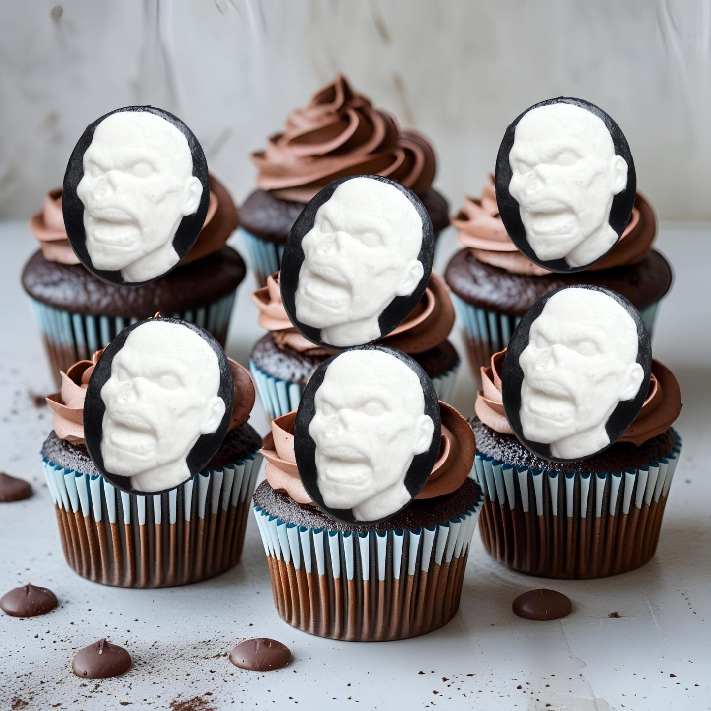 Cupcakes with white face zombies decorations on a light background