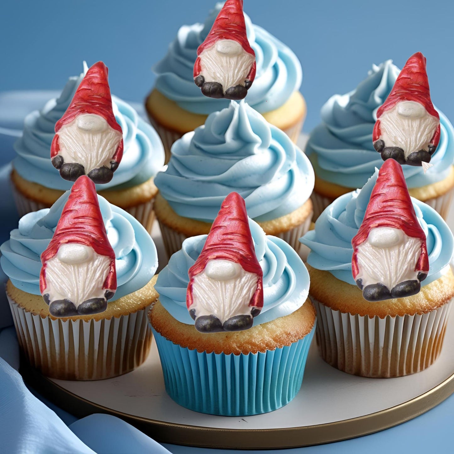 Cupcakes with blue frosting and Red Hat gnome toppers on a plate.