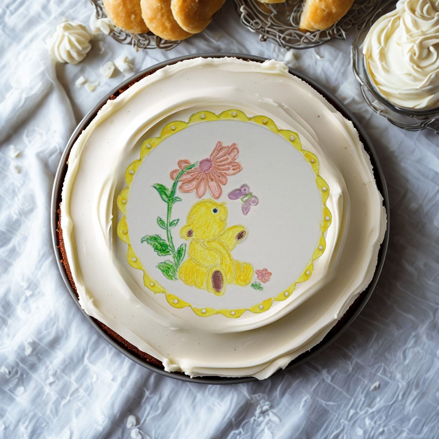 Yellow Teddy cake topper on top of a cream cake