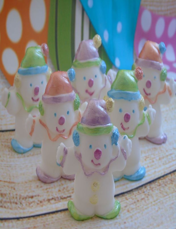 Clown cupcake toppers waving in front of a flag background