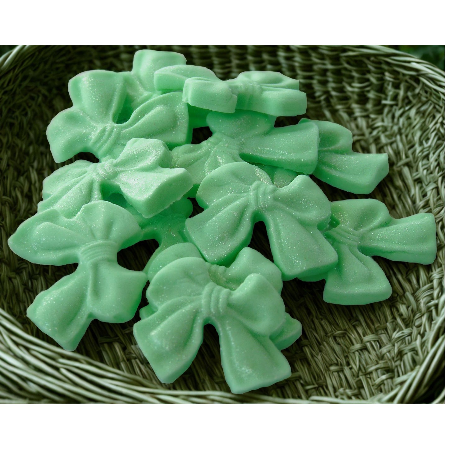 Green glittered edible bows design shows them in a woven basket
