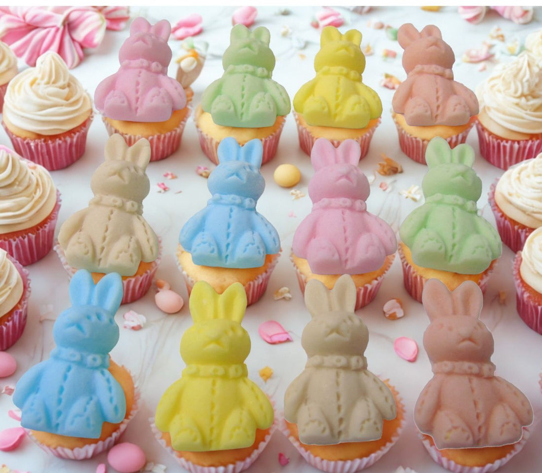 Coloured rabbits on top of cupcakes