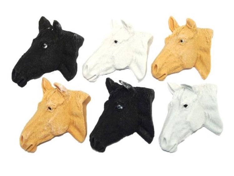 A collection of horse head cake toppers