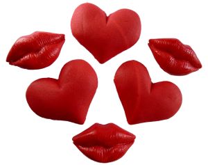 A collection of valentine's cake toppers. There are heart cake toppers and lip cake toppers. 