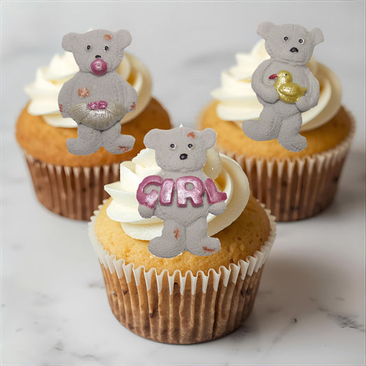 Cupcakes with  grey teddy bear toppers on a marble surface
