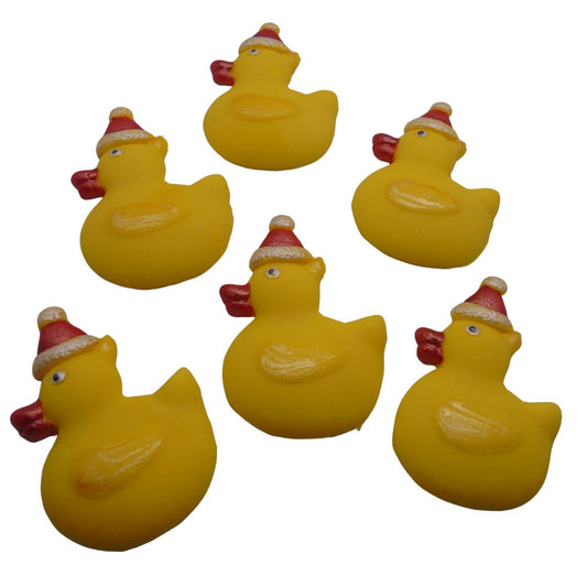 Six yellow Christmas ducks cupcake toppers wearing Santa hats on a white background