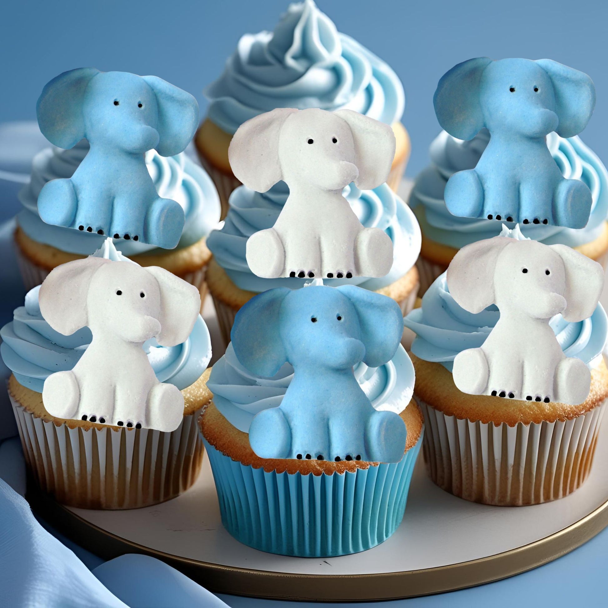 Cupcakes with blue and Grey elephant decorations on a blue background