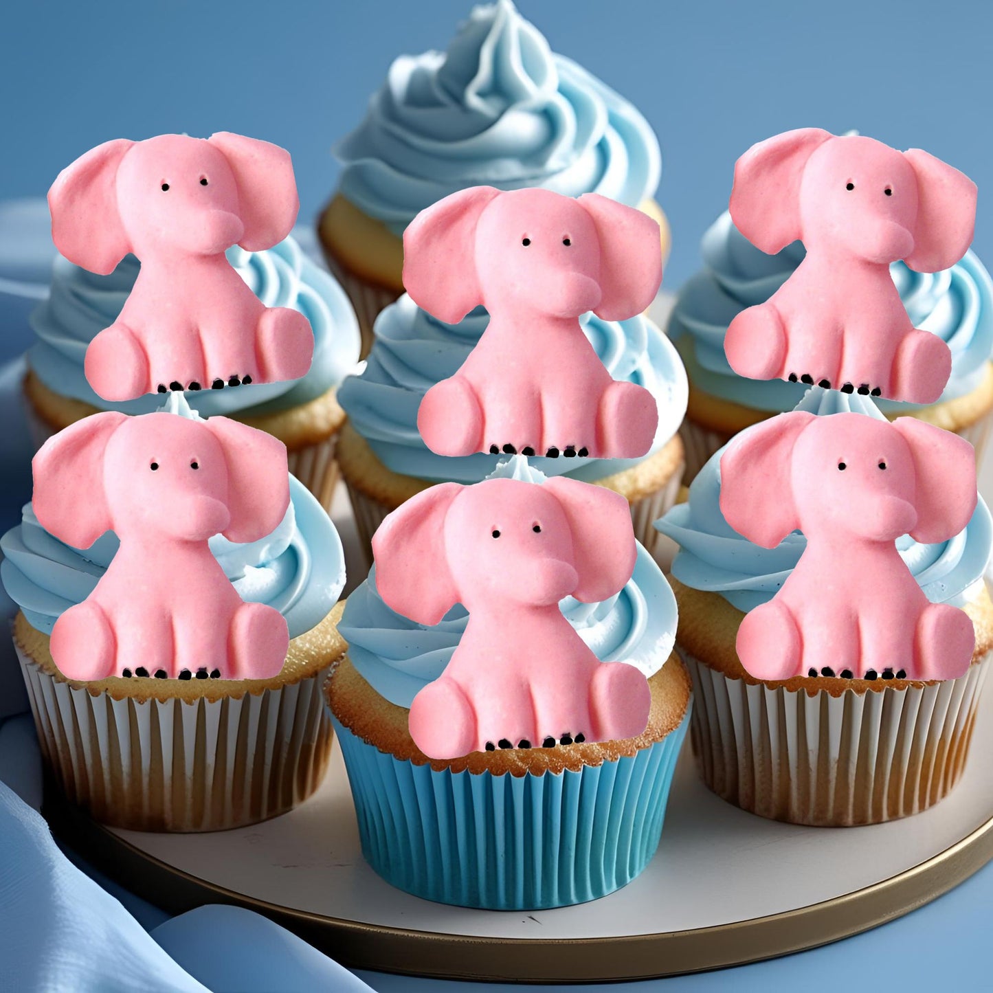 Cupcakes with pink elephant toppers on a blue background