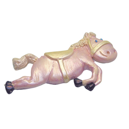 Pink horse figurine cake decorations with gold saddle on a white background