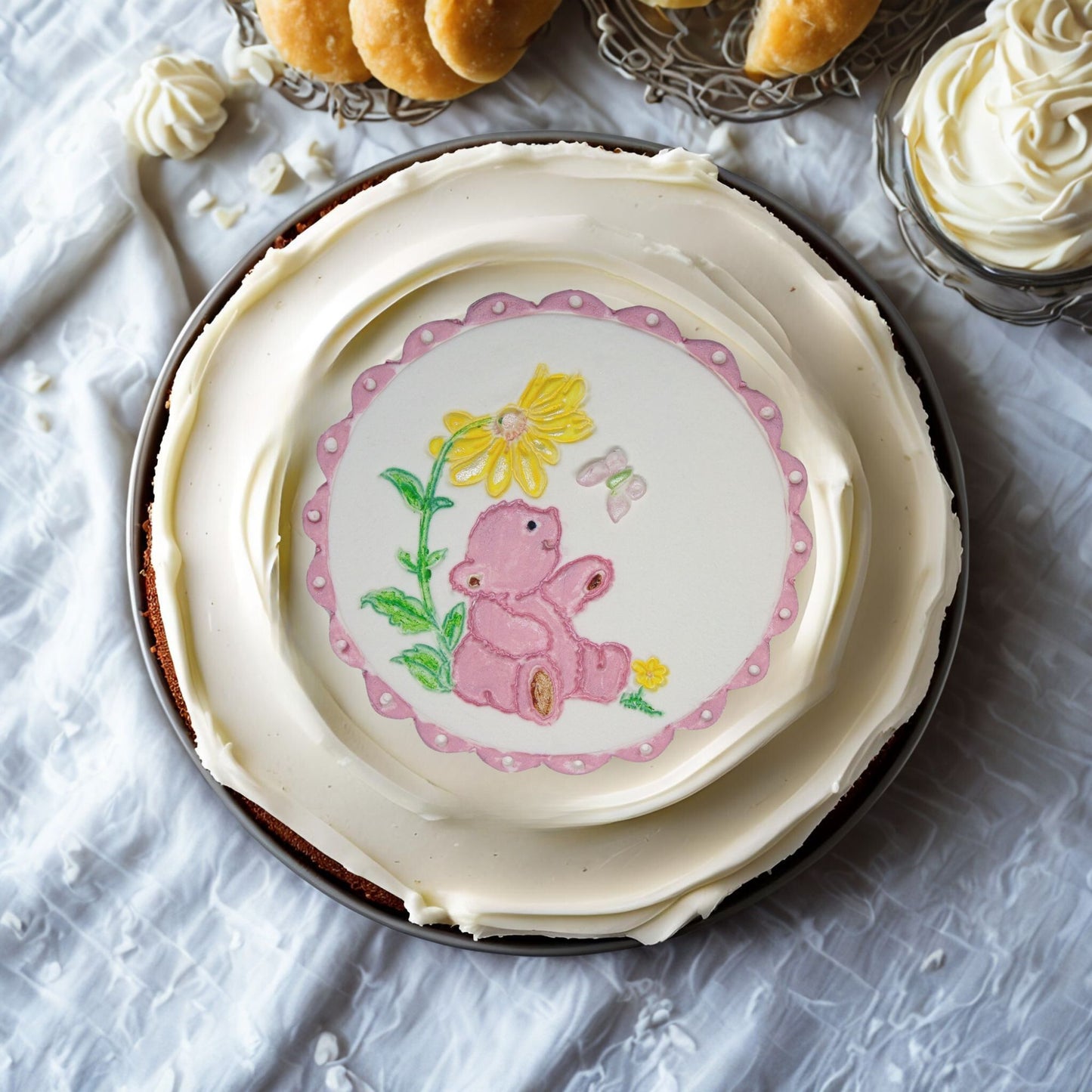 Pink Teddy cake topper on top of a cream cake