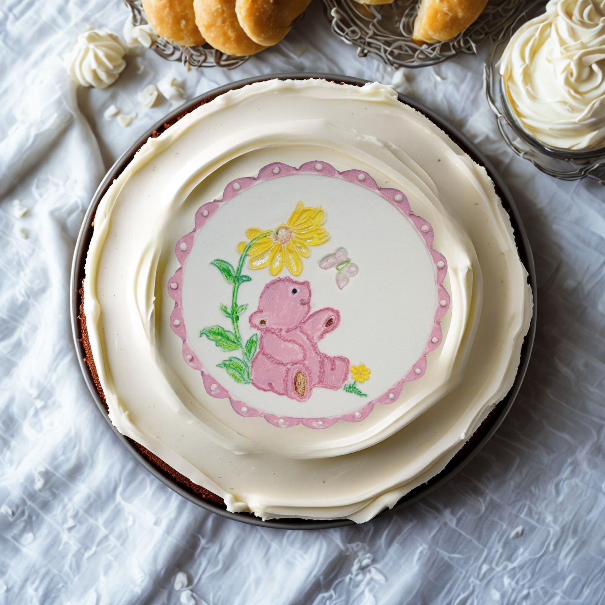 Pink Teddy cake topper on top of a cream cake
