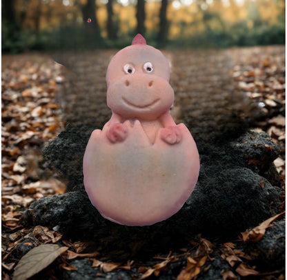 Baby dinosaur  cake decorations in egg  shown in natural woodland